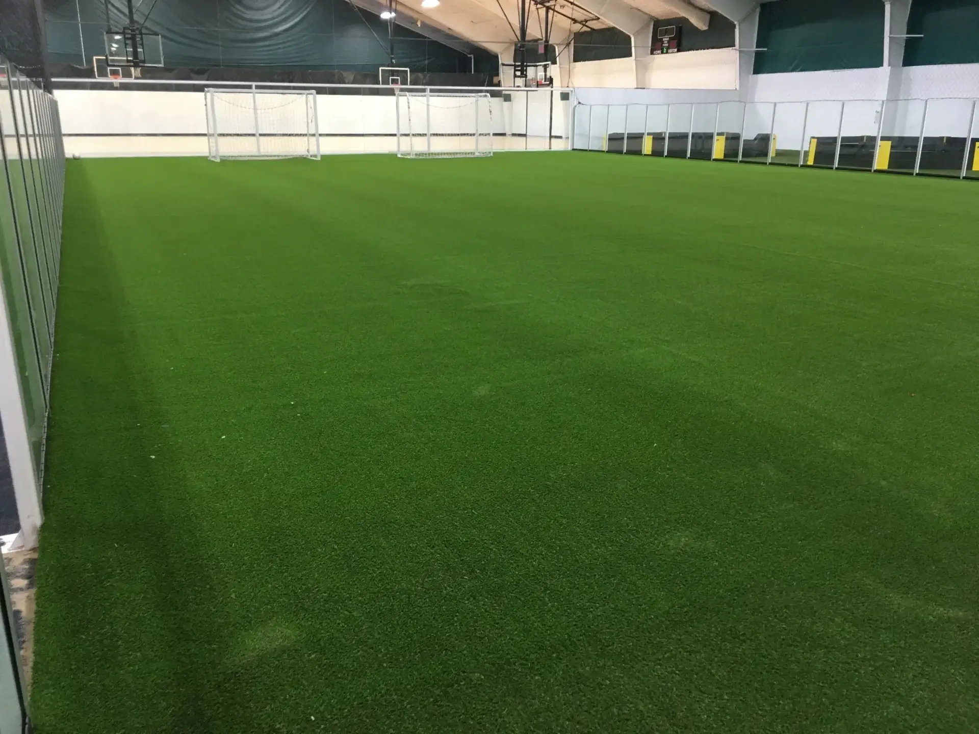 Indoor soccer field with artificial turf.