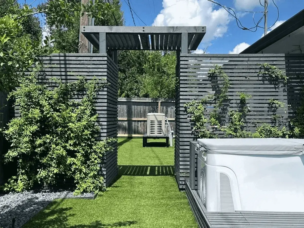 Gray slatted pergola entrance and covered hot tub